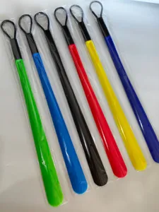 Detailed view of long plastic shoehorns in vibrant colors with hanging loop design.