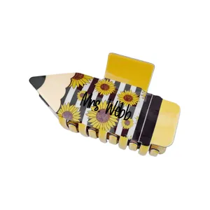 Detailed close-up of a custom pencil-shaped hair claw clip featuring sunflower patterns