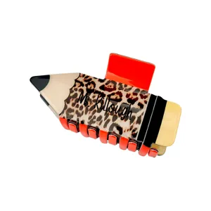 Detailed view of pencil-shaped hair claw clip with custom name and leopard print