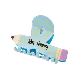 Detailed macro view of a creative pencil shaped hair claw clip with Mrs. Howry text