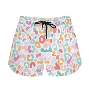 Detail showing vibrant abstract leopard print on white summer casual sports shorts