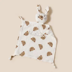 Close-up of customized embroidered name on a white muslin baby bunny security blanket