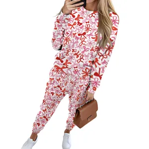 Casual women's two-piece tracksuit featuring an all-over red and pink bow print design