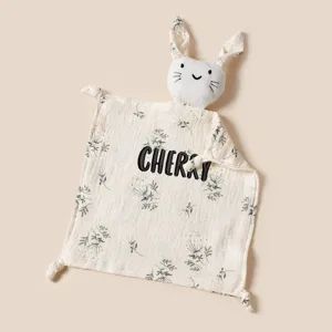 Detailed view of muslin baby security blanket with embroidered name and bunny head