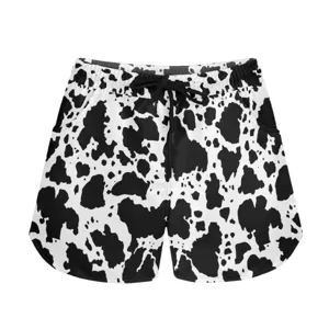 Detail view showing the bold cow print texture and drawstring of these casual sports shorts.