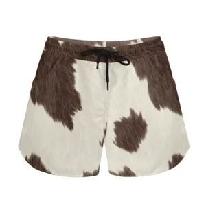Detail view of casual cow print shorts with black drawstring and elastic waist.