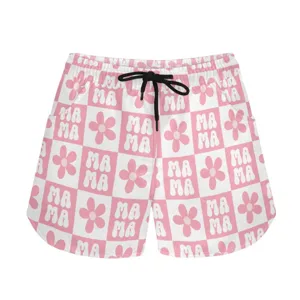 Detailed view of pink checkered sports shorts featuring Mama and flower patterns