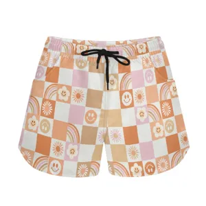 Detailed view of casual shorts featuring checkered pattern with smiley faces and rainbows