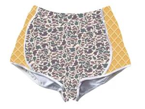 Detailed view of women's camo shorts featuring orange waffle grid side panels
