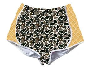 Detailed view of women's high-waisted camouflage sports shorts with yellow side panels