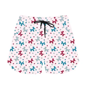 Close-up of pink casual shorts featuring a playful red and blue balloon dog pattern.