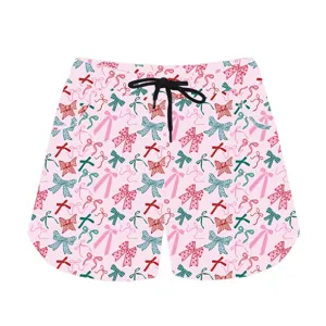 Close-up of pink casual shorts featuring a multi-colored bow print and black drawstring