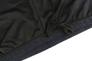 Close-up of black men's swim trunks waistband with drawstring and pattern.