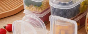 Clear plastic food storage container detail showcasing fresh fruit and meal prep organization.