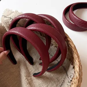Wine red faux leather braided headband detail shot showcasing textured crocodile pattern surface.