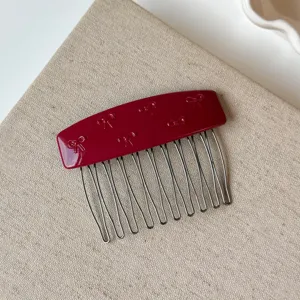 Pettine per capelli in resina rossa con fiocco per acconciatura femminile, accessorio elegante.