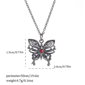 Macro view of gothic black butterfly necklace pendant with red gem and size measurements