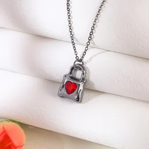 Close-up of a gothic gunmetal necklace featuring a vibrant red heart gemstone pendant