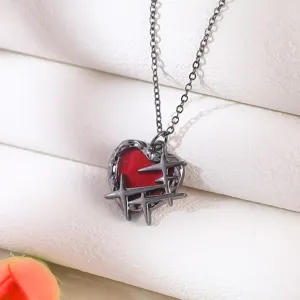 Macro view of gothic spiky heart pendant in red and dark metallic finish