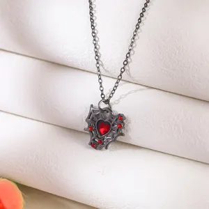 Detailed macro shot of the Gothic spider web heart pendant with red stones