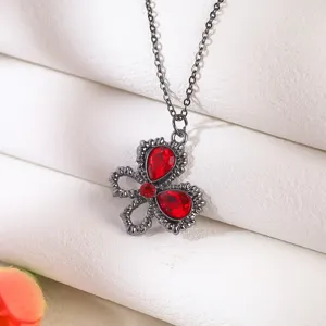 Detailed view of a gothic gunmetal necklace with teardrop-shaped vibrant red gems.