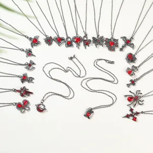 Detailed macro view of Gothic style necklaces collection featuring red heart and spider charms