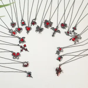 Detailed display of Gothic necklaces with red hearts, crosses, spiders and bat pendants