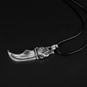 Detailed macro view of Viking wolf tooth pendant with intricate Nordic carvings and texture
