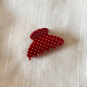 Red polka dot hair claw detail, elegant acetate hair clip, cute hairpin for women styling.