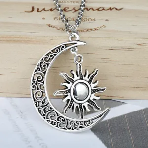 Close-up of antique silver sun and moon pendant necklace with filigree detail