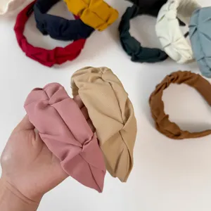 Detailed view of fashionable pleated fabric headbands, chic knotted design for daily wear.