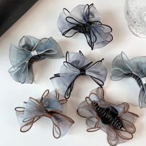 Details of gradient mesh bow hair claw clip, sweet Korean style shark clip for daily hair styling.