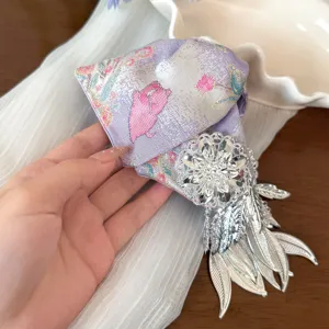 Detailed shot of Chinese style embroidered hair claw clip with elegant silver leaf tassels.
