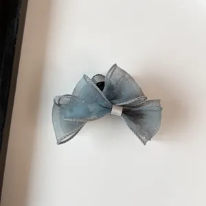 Close-up of grey organza hair claw clip with starry sparkle and delicate edge.