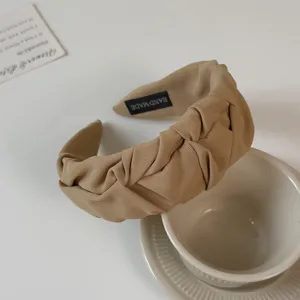 Beige pleated wide fabric headband hair hoop detail, elegant braided hair accessory.