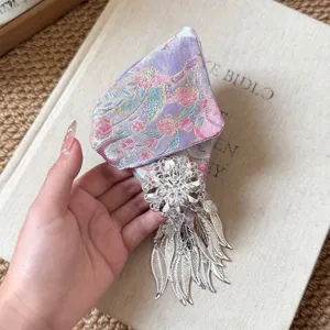 Detailed Chinese style hair claw clip featuring purple brocade and silver leaf tassels.