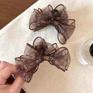 Brown floral sheer organza hair claw clip, delicate double bow design for elegant half-up hairstyles.