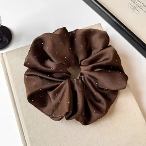 Brown satin rhinestone scrunchie detail shot, elegant starry hair tie for low ponytail.