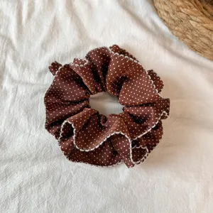 Brown polka dot hair scrunchie detail shot, ruffled pleated hair tie design for women daily wear.