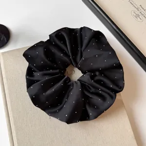 Elegant black satin hair scrunchie with sparkling rhinestones for daily chic low ponytail styling.