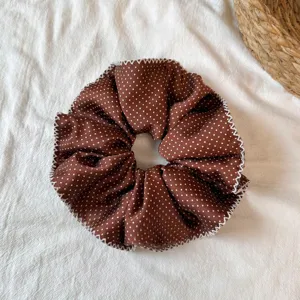 Brown polka dot hair scrunchie with white stitch edge, elegant daily hair accessory detail.