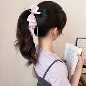 Korean sweet pink satin hair bow banana clip detail showcasing elegant streamer design and rhinestone.