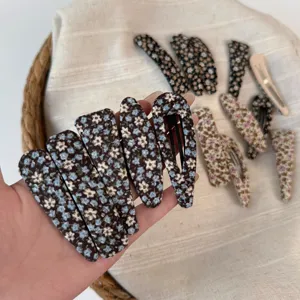 Close-up detail of Korean pastoral style floral fabric snap hair clips, cute hair accessories.