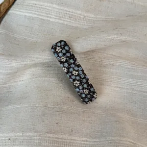 Floral fabric hair clip detail close up, elegant blue and black retro hairpin for daily wear