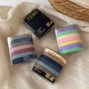Detailed view of boxed high-elasticity basic hair ties in vibrant assorted colors for daily styling.