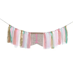 Detailed view of pink 1st birthday high chair banner with assorted ribbons and lace