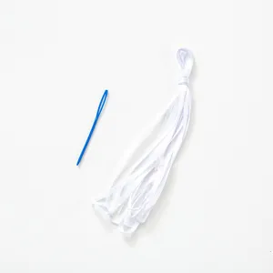 White satin ribbon bundle and blue plastic threading needle for DIY banner assembly kit
