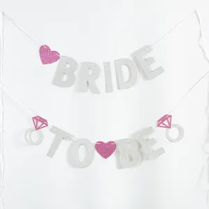 Glittery 'BRIDE TO BE' wedding party banner with pink hearts and diamond rings decoration