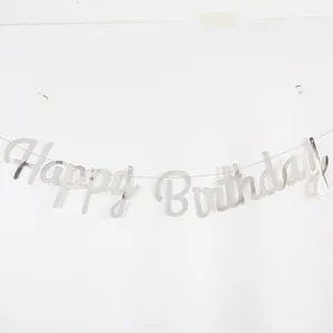 Close-up of reflective silver Happy Birthday cursive letter banner for party wall decoration