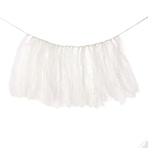 Close-up of white tulle high chair banner with delicate glitter moon and star patterns